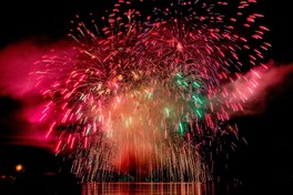 赤と緑が彩る幻想的な水上花火